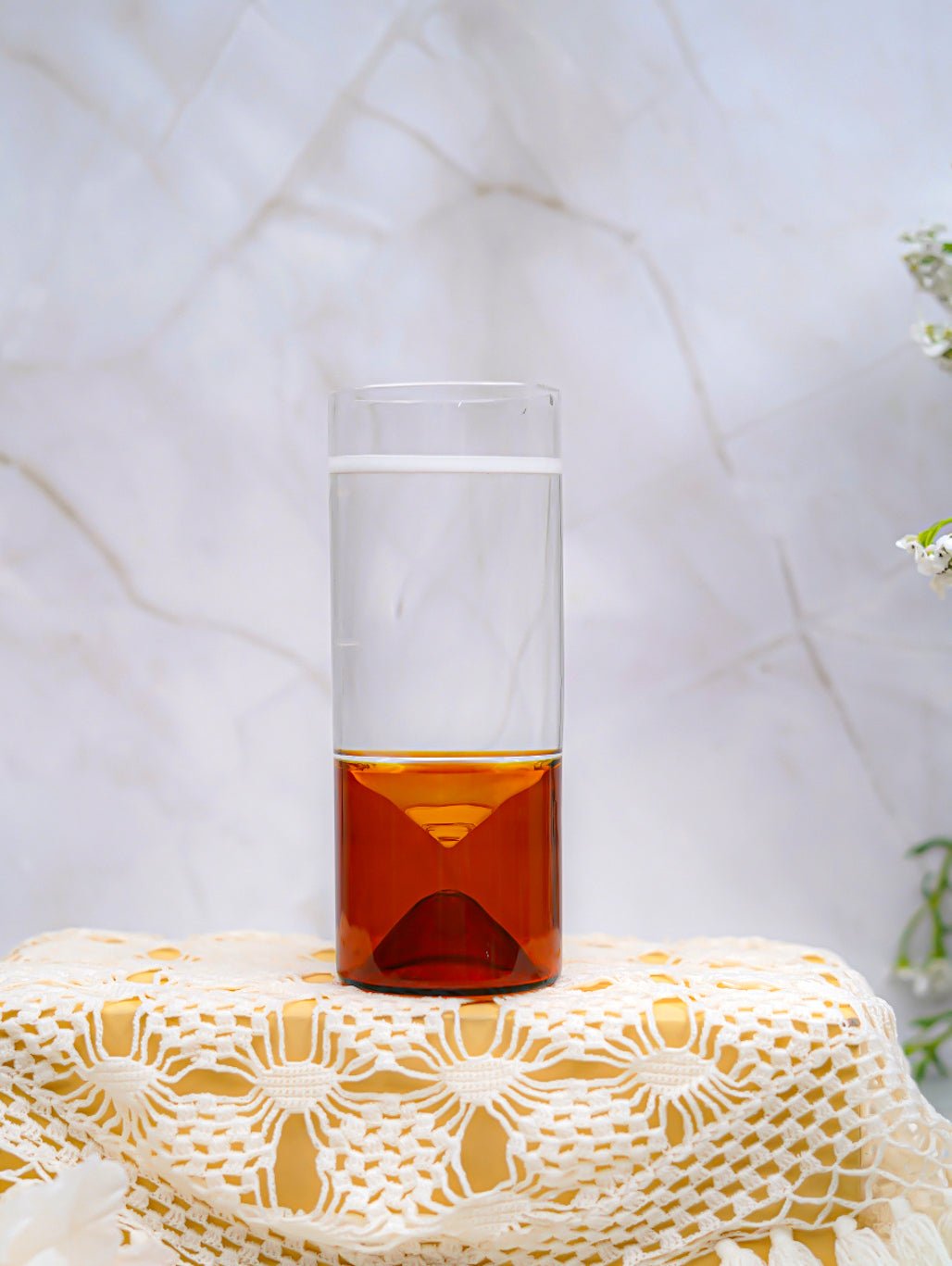 Refreshing drink served in a 260ml borosilicate highball glass with a green geometric base, stylish and durable.