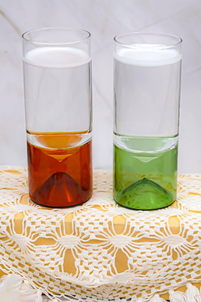 Geometric base borosilicate highball glass, perfect for cocktails and juices, with a modern green touch