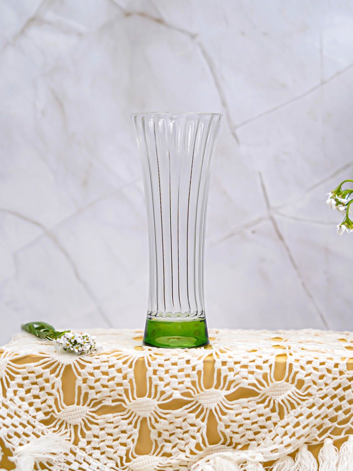 Refreshing juice served in a borosilicate ribbed glass with green base, perfect for stylish and practical drinkware.