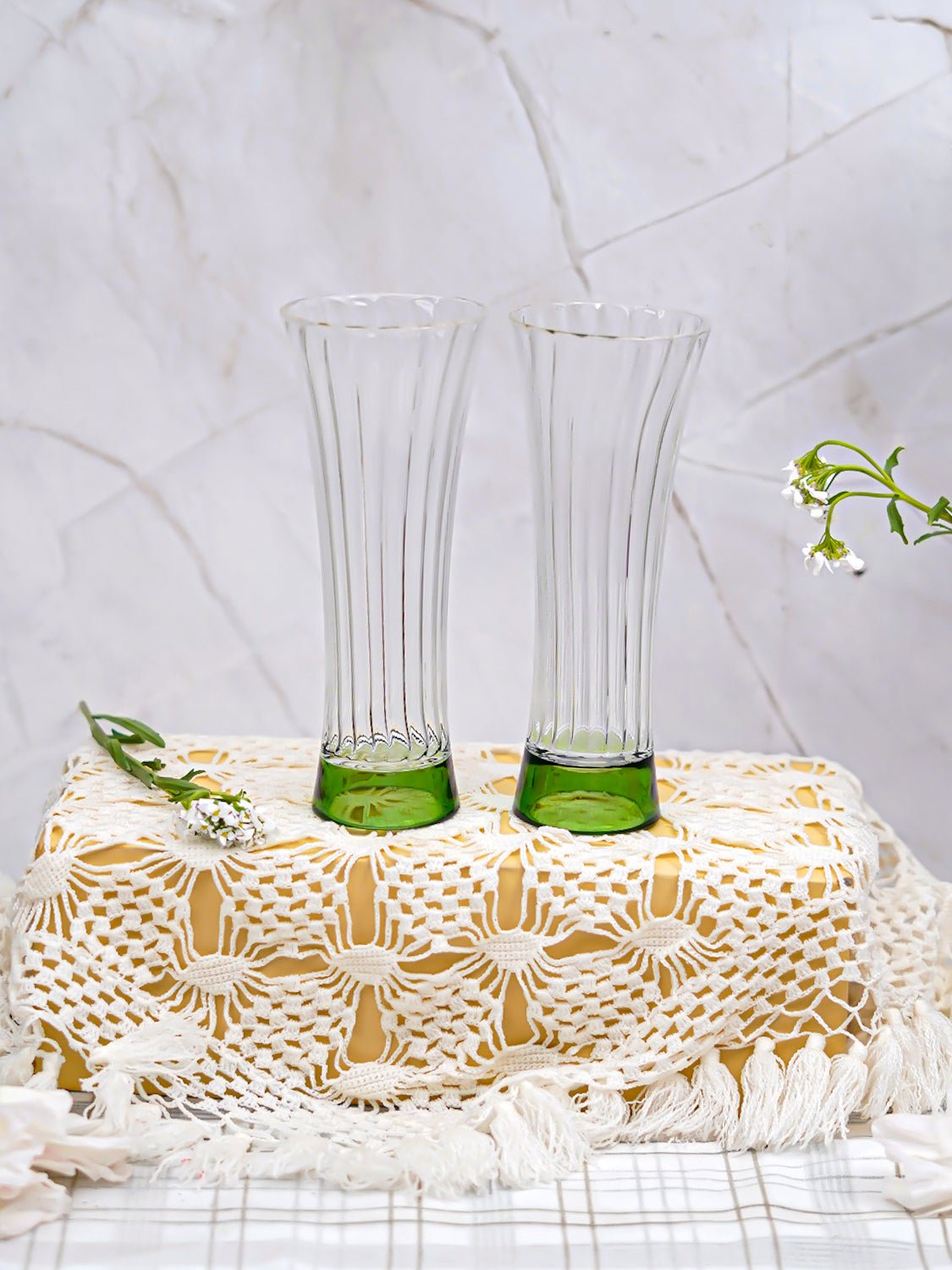 Green-base ribbed borosilicate juice glasses, perfect for serving fresh juices with a modern and durable design.